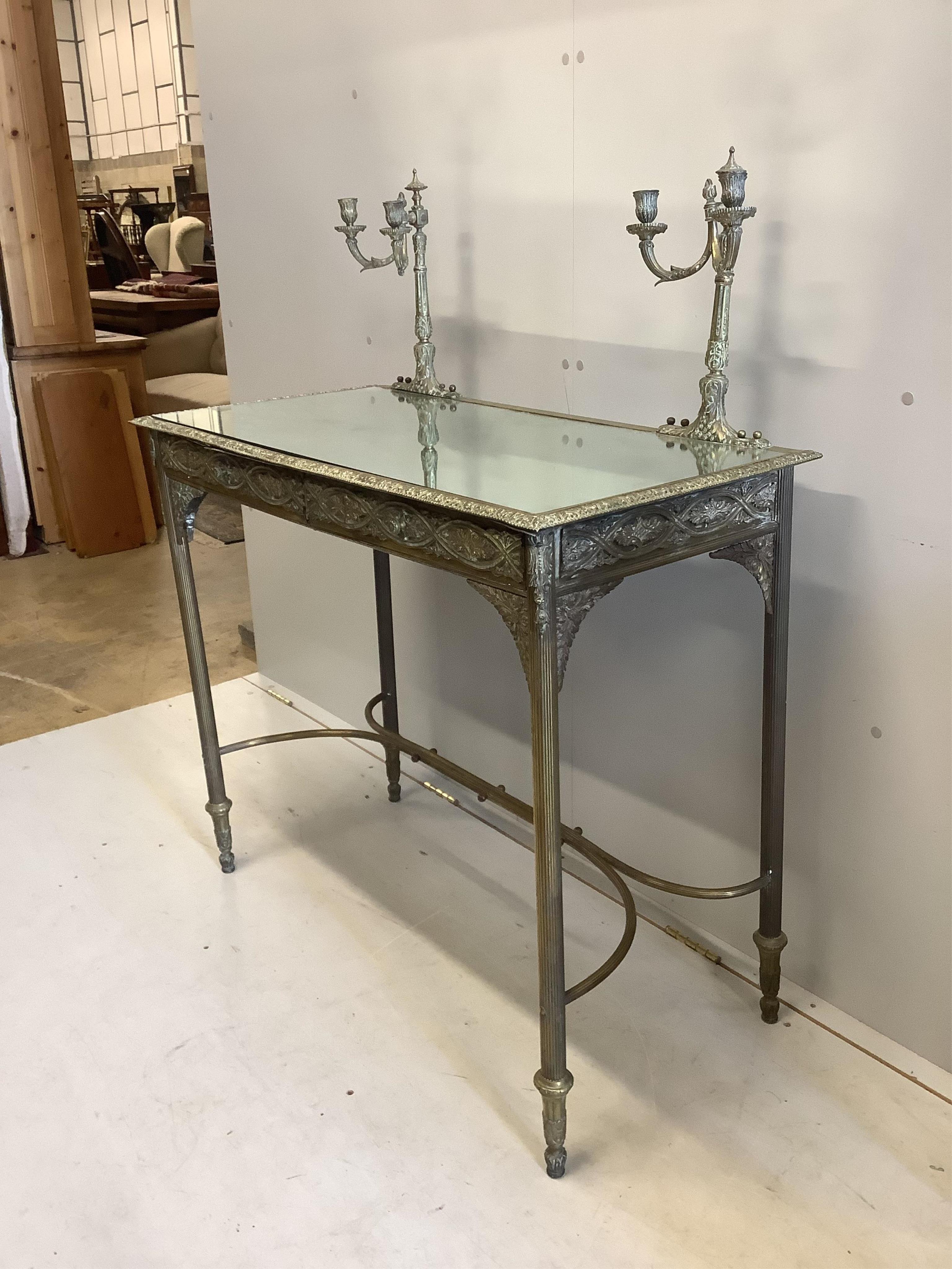 A brass and mirrored console table, width 96cm, depth 48cm, height 118cm. Condition - fair